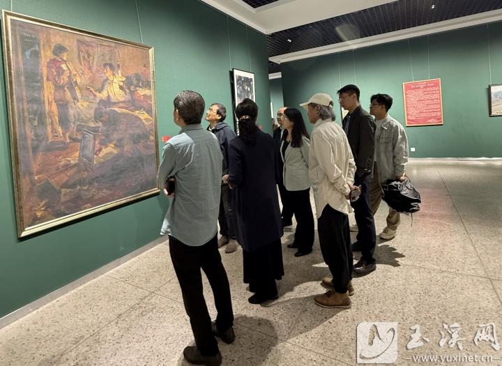 展覽現(xiàn)場，侯一民油畫作品《地下工作者》引來觀眾品評(píng)、欣賞。